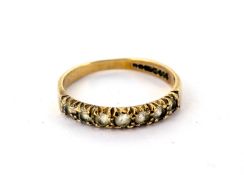 A 9ct gold channel set ring with seven white stones, size M, weight approx. 1.5g.