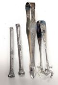 A pair of George III silver sugar tongs, together with two silver propelling fountain pens