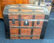 A wood, metal and leather-bound Victorian Steamer Trunk with dome top