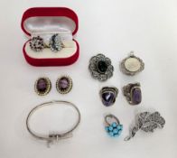 A small collection of silver jewellery to include two large silver rings set with purple stones, a