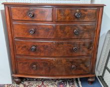 A Victorian figured mahogany bow front chest of drawers with brass escutcheons