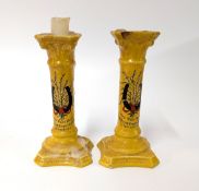 A pair of yellow British Empire Exhibition candlestick holders, height approx. 18cm. (2)