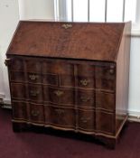 An 18th/19th century burr walnut Dutch bureau with fitted stepped interior