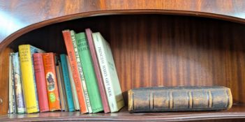 A collection of books, including children story books and an early family photograph album.