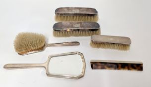 A four piece silver back dressing table set, with a pair of silver back brushes.