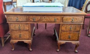A reproduction walnut pedestal desk (three sections), width 138cm, depth 77cm.