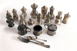 A collection of silver salt and pepper pots, table salt pots, small spoons and fork