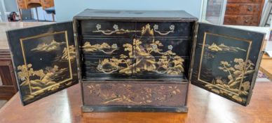 A metal and lacquer miniature chest with fitted six drawer interior, decorated with painted
