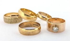 A group of five wedding style bands, including four 9ct gold, each of varied design