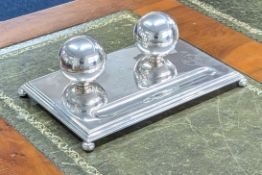 A George V silver pen and ink stand on bun feet, inscribed and decorated