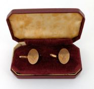 A pair of 9ct gold oval face cufflinks, with fleur-de-lis engraving, weight approx. 4.7g.
