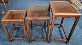 A set of three Chinese carved nesting tables, largest height approx. 58.5cm. (3)