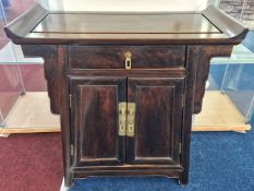 A 20th century Chinese Altar style cabinet, with curved top surface, brass handles