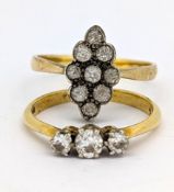 Two dress rings, including a three stone diamond ring, indistinctly marked 18, size K, 2.1gms