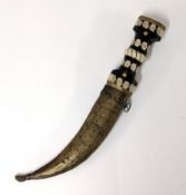 A Middle Eastern curved dagger with scabbard.