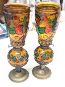 A pair of oil lamps decorated with stained glass.