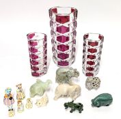 Three glass vases together with carved stone elephants etc.