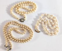 A one row freshwater pearls set with a 9ct gold clasp together with two sets of faux pearls.