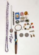 A small collection of costume jewellery including brooches, clip on earrings, silver locket,