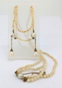 A fine antique pearl and diamond double row drop necklace, two strands of alternating size small