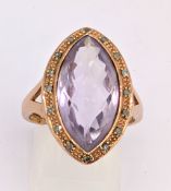 A 9ct rose gold amethyst & diamond ring, set with a mixed faceted-cut marquise shaped amethyst
