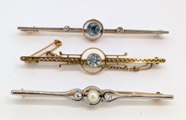 A group of three early 20th century gem-set brooches, each of varied 'target' style design, set with