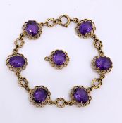 An amethyst bracelet, of openwork floral design, claw set with six oval-cut amethyst, bolt ring