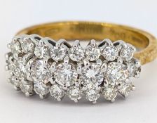 An 18ct gold triple row diamond ring, claw set with three rows of brilliant-cut diamonds, the