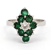 An 18ct gold diamond and emerald marquise ring, claw set to the centre with a brilliant-cut diamond,