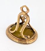 A carved fob seal, the oval yellow hardstone seal carved with an image of a ram, unmarked, length