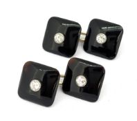 A pair of Art Deco onyx and diamond cufflink, each onyx plaque centrally milgrain set with a