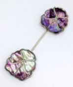 An Art Nouveau silver and mother of pearl pansy cloak pin, each petal set with iridescent purple