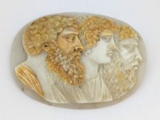 A carved cameo shell, of oval form carved depicting three classical profiles, measuring approx. 5.