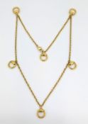 Gucci, an 18ct gold horse bit necklace, curb link chain interspaced with six horse bit drops,