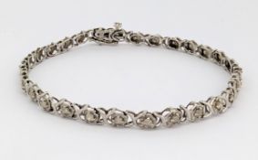 A 9ct gold diamond bracelet, of articulated openwork 'X' style links, each illusion set with a small