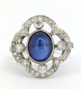 A fine early 20th century cabochon sapphire and diamond ring, of flowerhead form, milgrain set to