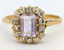 An antique gemstone and diamond cluster ring, claw set to the centre with an emerald-cut pale pink