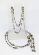 A long fancy link chain, possibly French Art Deco, interspaced with faux pearls, indistinct marks,
