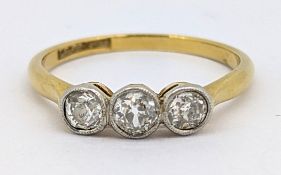 A three stone diamond ring, milgrain collet set with three old-cut diamonds, diamonds approx. 0.54