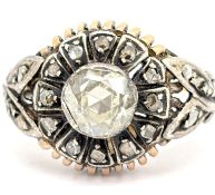 A Victorian diamond cluster ring, collet and enclosed back set to the centre with an old-cut