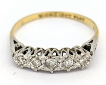 A seven stone diamond ring, illusion set with a row of five graduated brilliant-cut diamonds, and