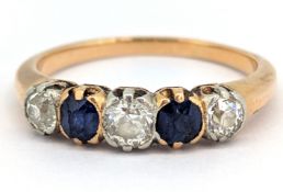 A diamond and sapphire five stone ring, set with three old-cut diamonds, each interspaced with a