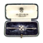 An Edwardian five stone diamond brooch, claw set with five old-cut diamonds in a foliate style