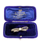 A Victorian diamond bow brooch, claw set to the centre with a cushion-cut diamond, diamond approx.