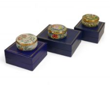 Three Halcyon Enamelled hinged pill boxes to feature designs of 'Game Shooting', 'Floral/Fruit',