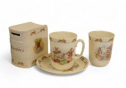 Royal Doulton Bunnykins to include a moneybox, saucer and two mugs. (4)