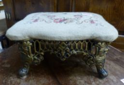 Small footstool with cast metal base and needlepoint top, 36cm x 27cm x 20cm.
