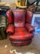 Ox blood red leather reclining armchair.