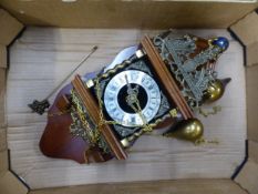 Mahogany wall clock in the Dutch style, weights and pendulum present.