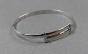 A white gold expanding christening type bracelet, (personalised to the interior) marked as 18ct,
